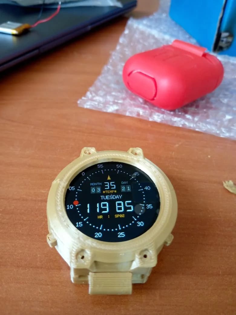 Early round Pre-Eclampsia Watch prototype on a work surface